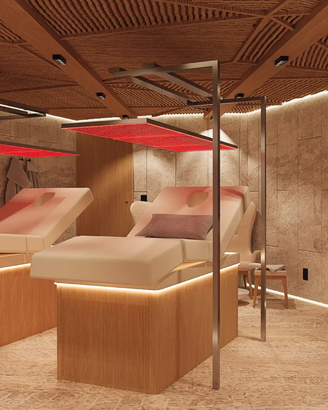 Sala de terapias do SPA Nanö, com macas sob painéis de luz vermelha